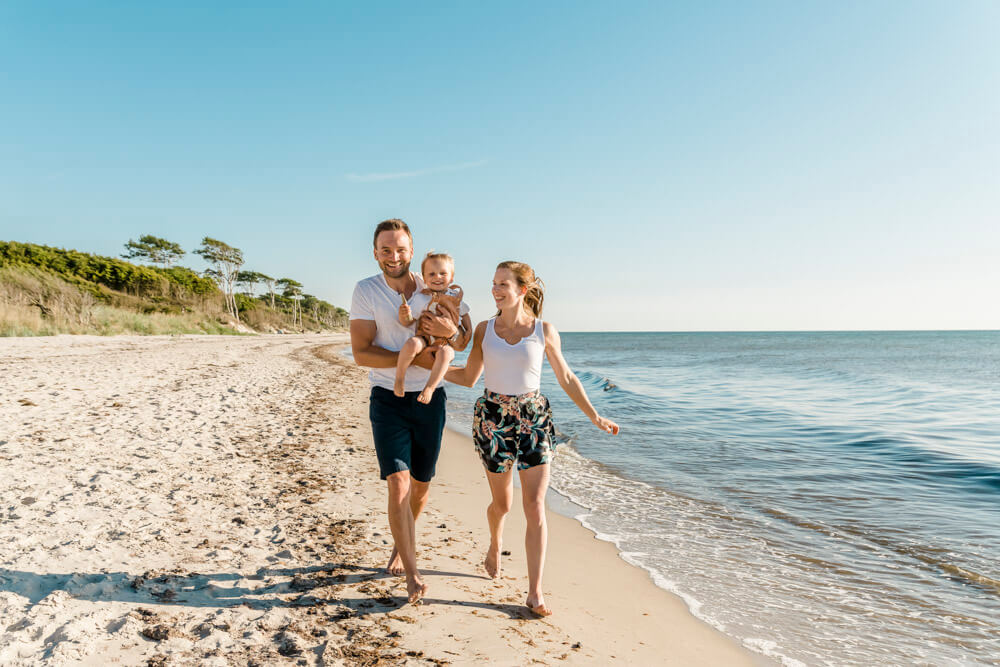 Familie rennt am Strand von Prerow entlang - ein schönes, ungestelltes Familienportrait.
