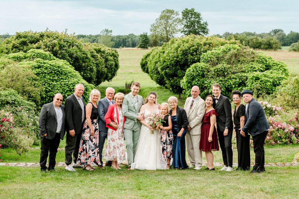 Gruppe posiert bei Hochzeit im Freien zusammen